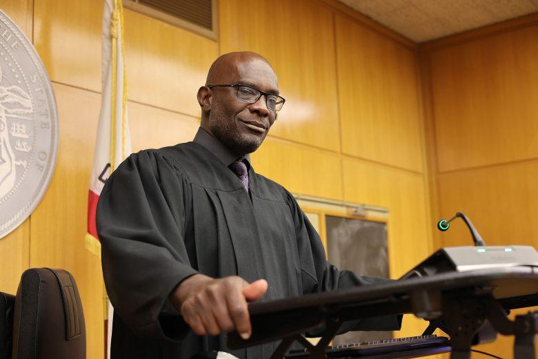 Judge Eric Fleming stands at the bench in a black judge's robe.